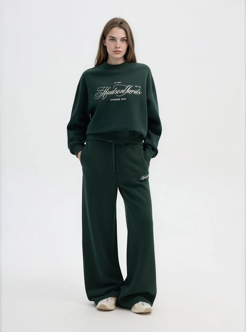 Pantaloni tuta wide leg con ricamo college