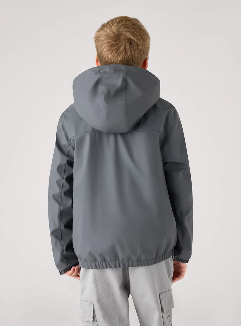 Giacca tecnica con cappuccio e zip