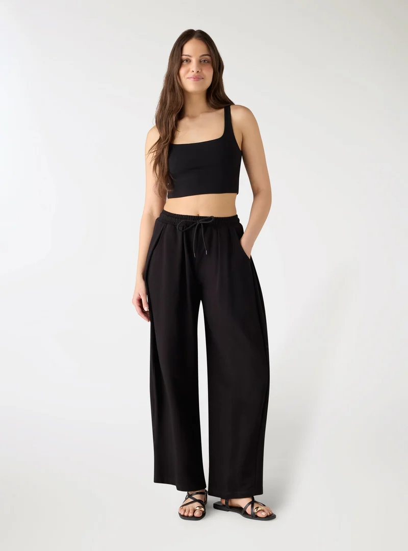 Pantaloni tuta wide leg taglio ampio con coulisse