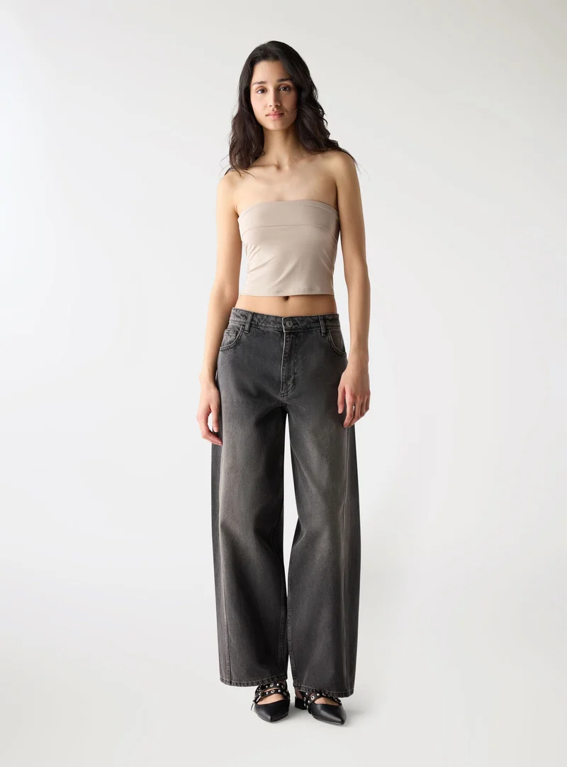 Jeans a barilotto con tagli laterali