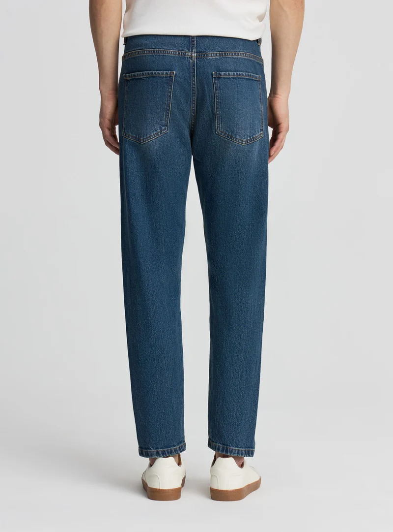 Jeans slim tapered a tinta unita