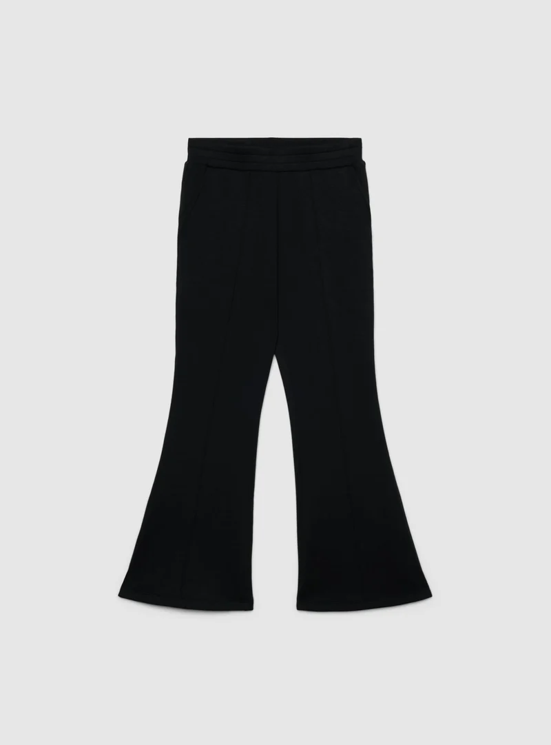 Pantaloni tuta a zampa tinta unita