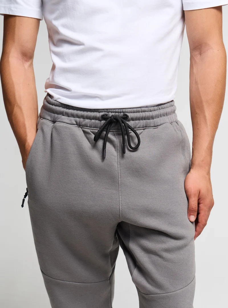 Pantaloni tuta con zip e coulisse