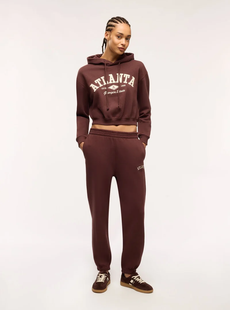 Pantaloni tuta vita alta con scritta college
