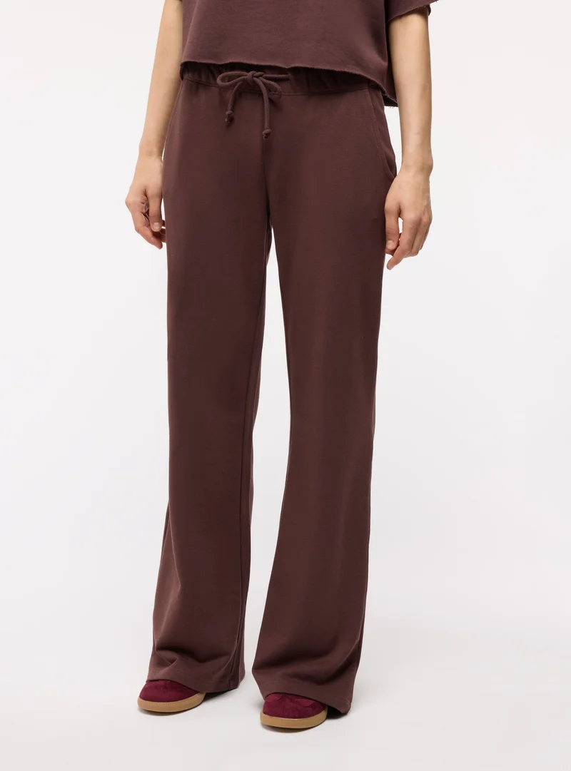 Pantaloni tuta ampi a zampa con coulisse