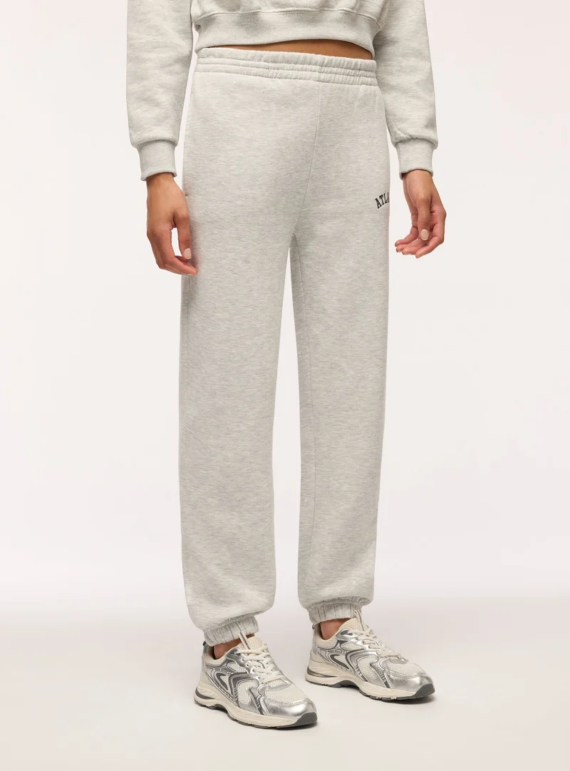 Pantaloni tuta vita alta con scritta college