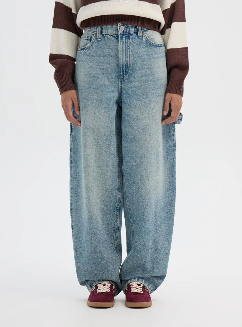 Jeans carpenter con cintura regolabile