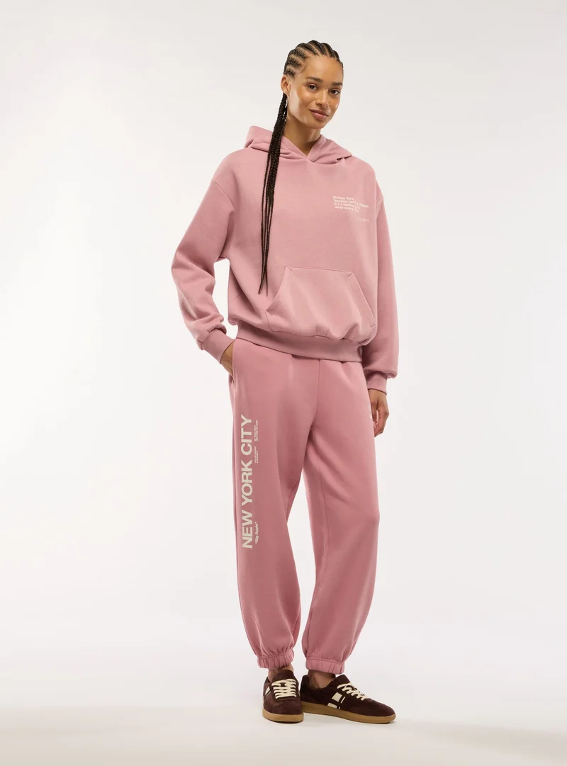 Pantaloni tuta con coulisse e scritta