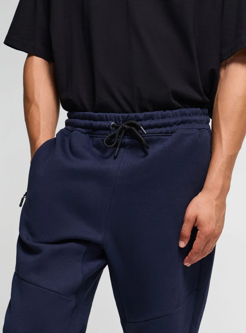 Pantaloni tuta con zip e coulisse