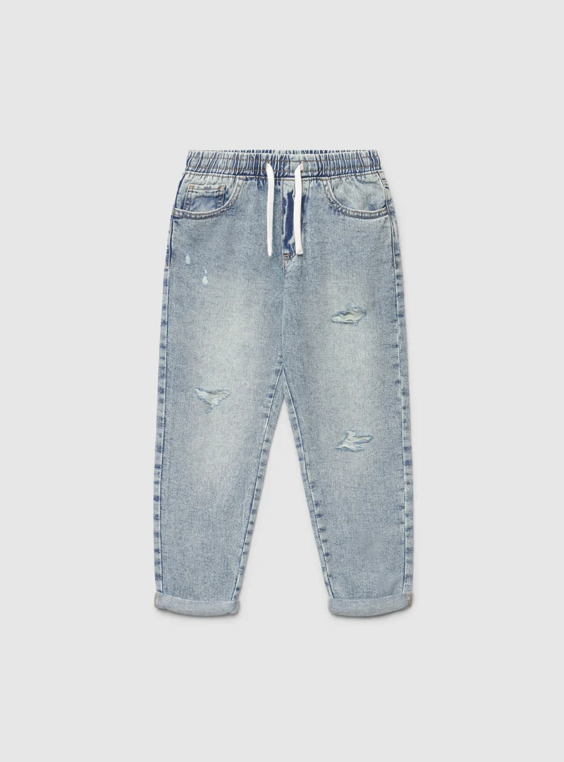 Jeans jogger con strappi e coulisse