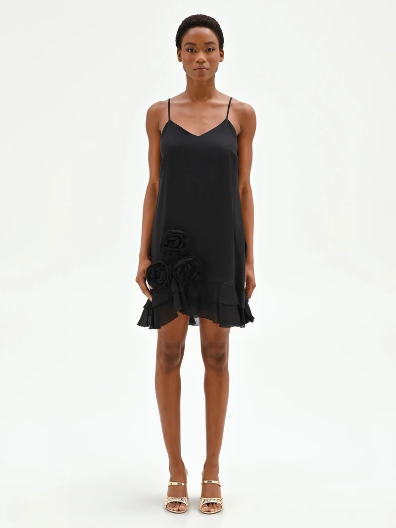 Mini abito nero in lyocell con rose applicate e balze