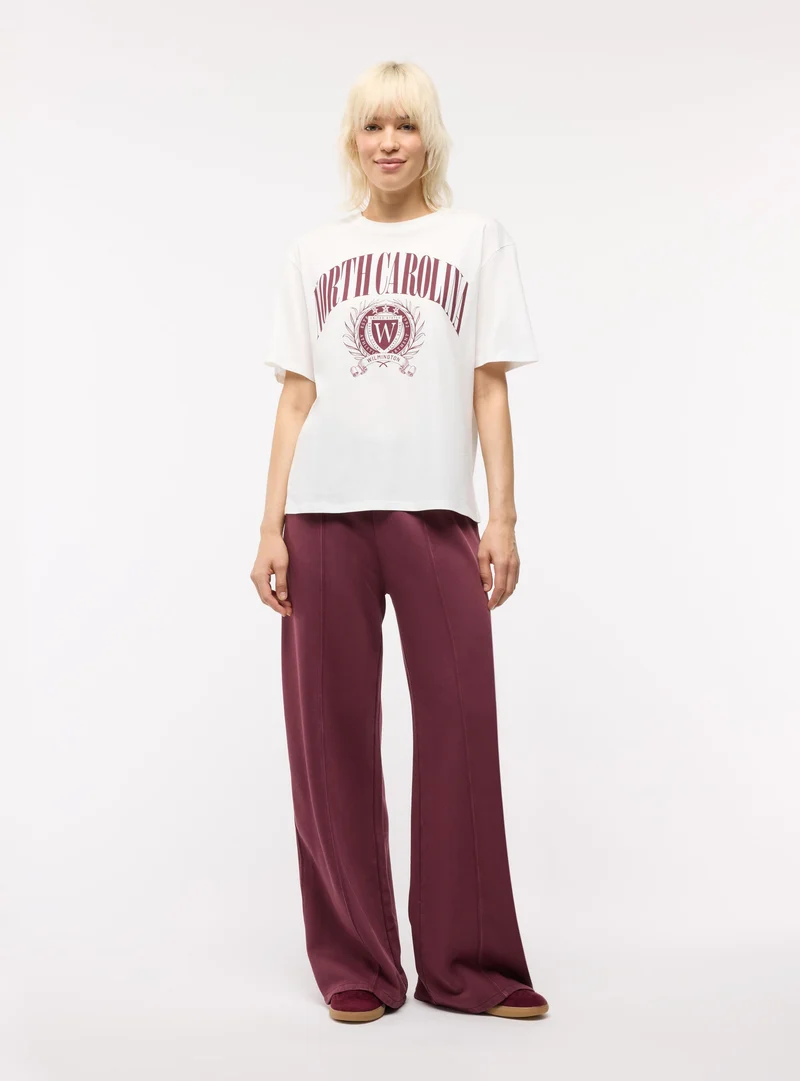 T-shirt maxi con stampa college