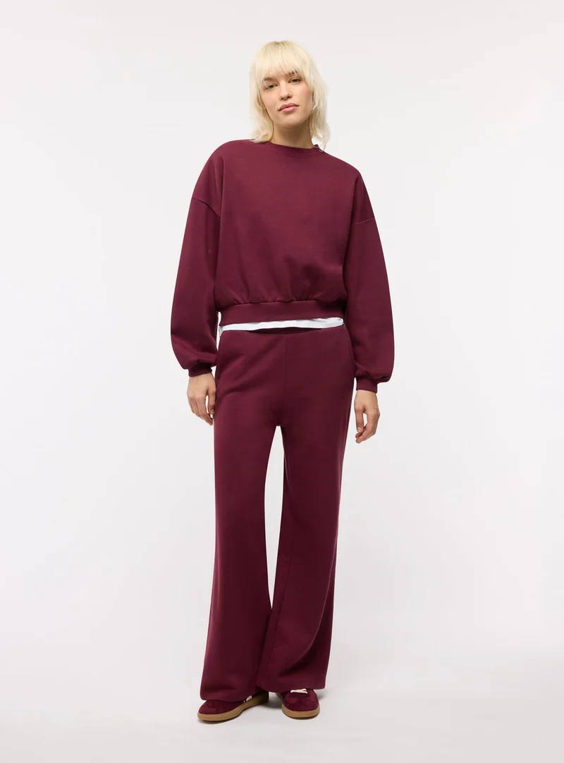 Pantaloni tuta wide leg con bande laterali