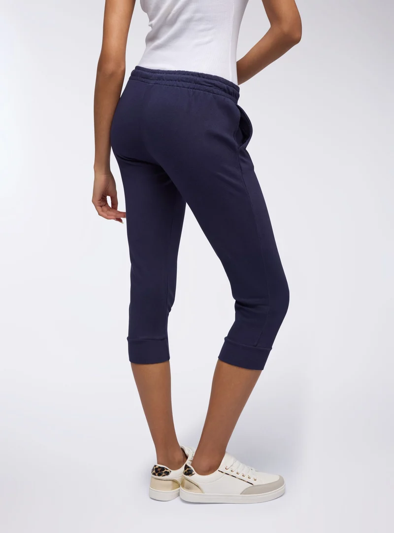 Pantaloni tuta pinocchietto con coulisse