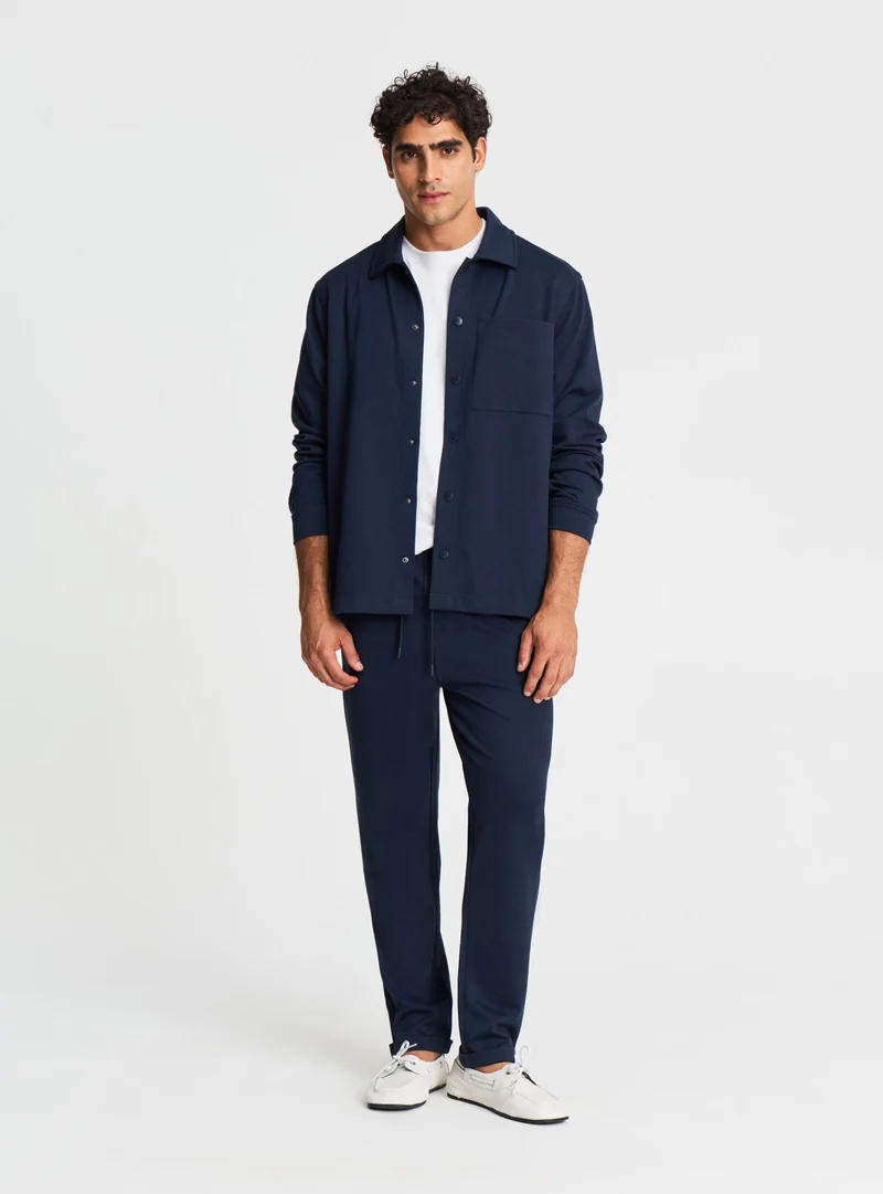 Pantaloni tuta lunghi in piquet con risvolto