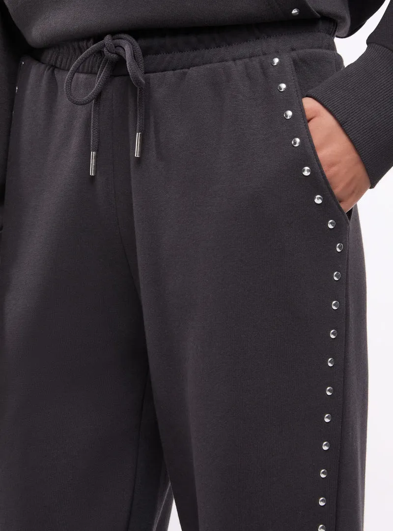 Pantaloni tuta wide leg con borchie
