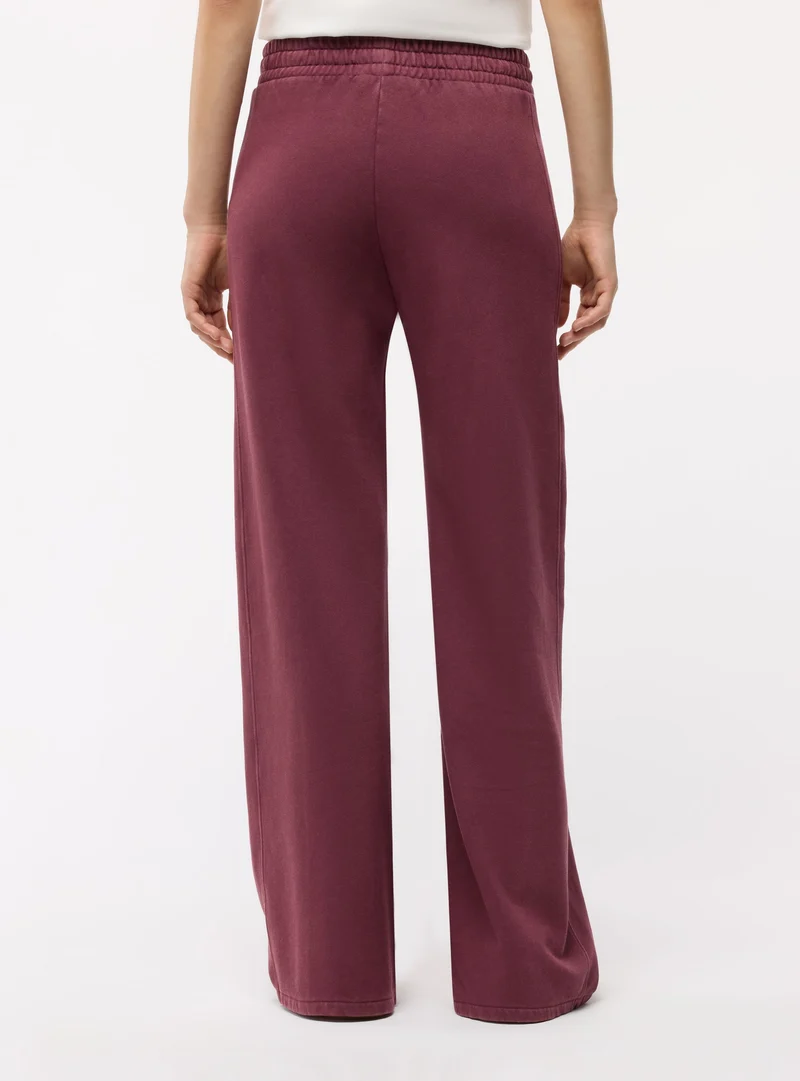Pantaloni tuta wide leg a tinta unita