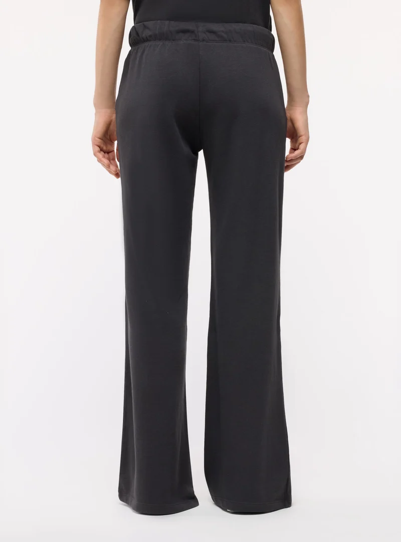 Pantaloni tuta ampi a zampa con coulisse