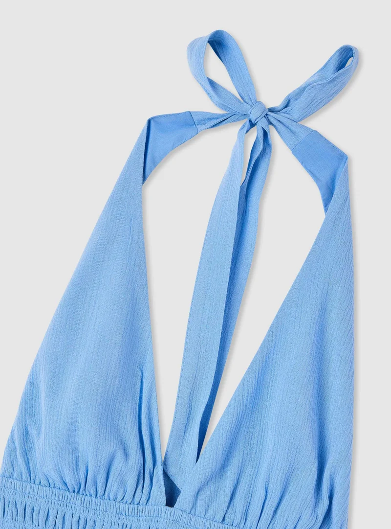 Tuta halterneck con bustino arricciato