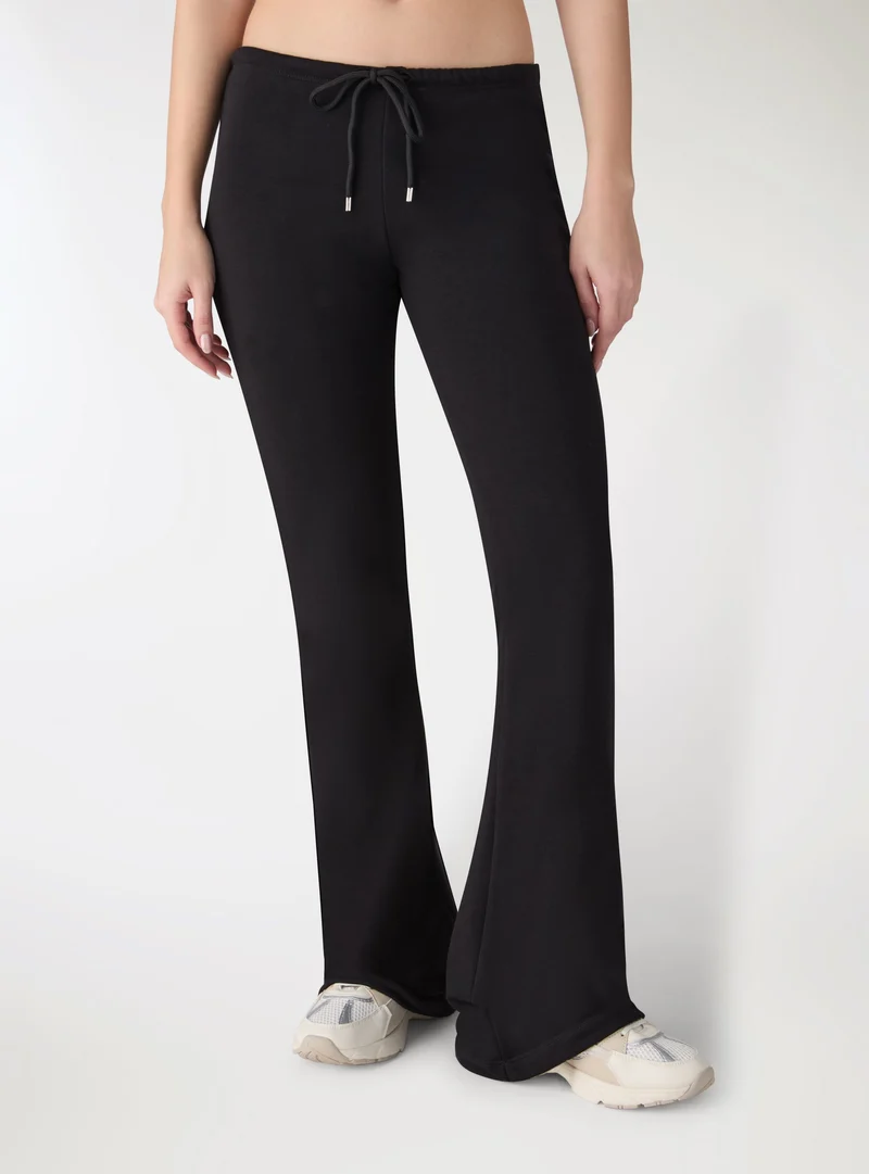 Pantaloni tuta lunghi a zampa vita bassa