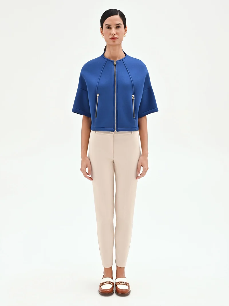 Capospalla cropped blu brillante con zip dorate