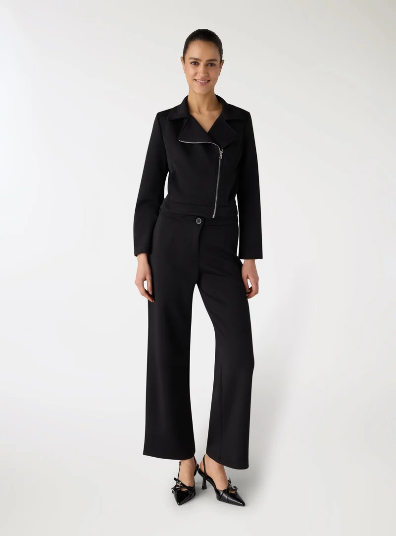 Chiodo crop con zip obliqua