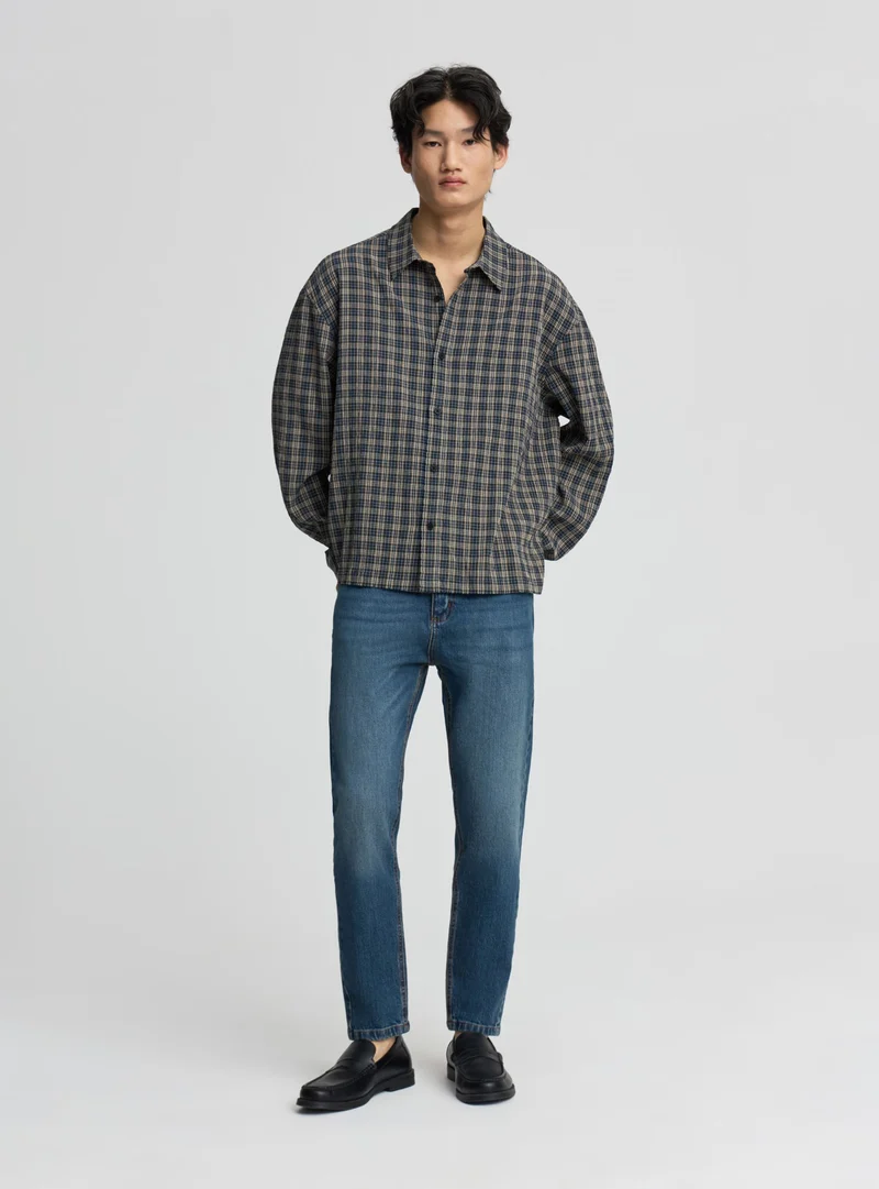 Jeans slim tapered a tinta unita