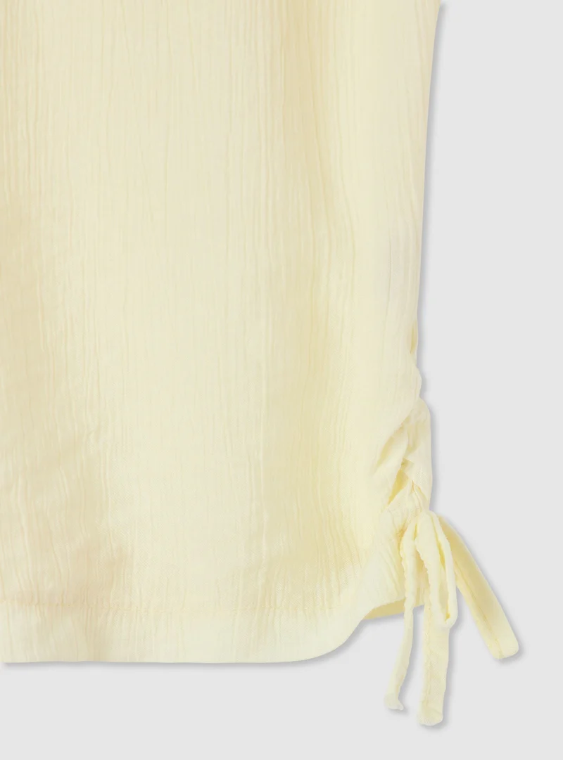 T-shirt a tinta unita goffrata con coulisse laterali