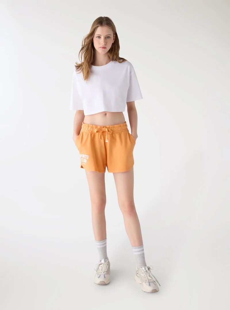 Shorts ginnici con elastico e coulisse