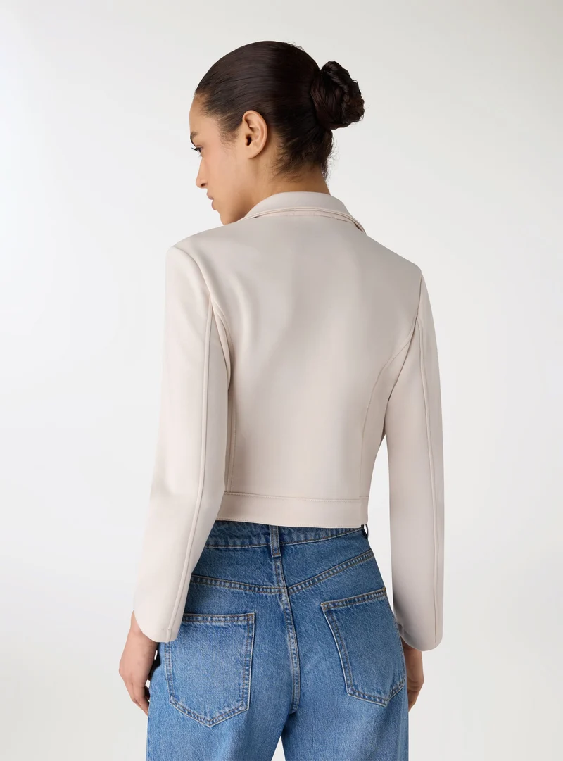 Chiodo crop con zip obliqua
