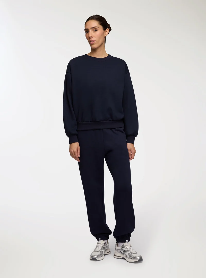 Pantaloni tuta vita alta con polsini