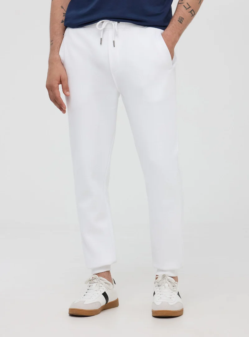 Pantaloni tuta pesanti con coulisse e polsini