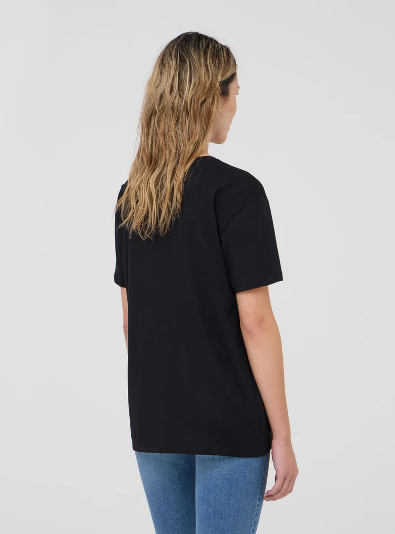 T-shirt ampia con ricamo fiore