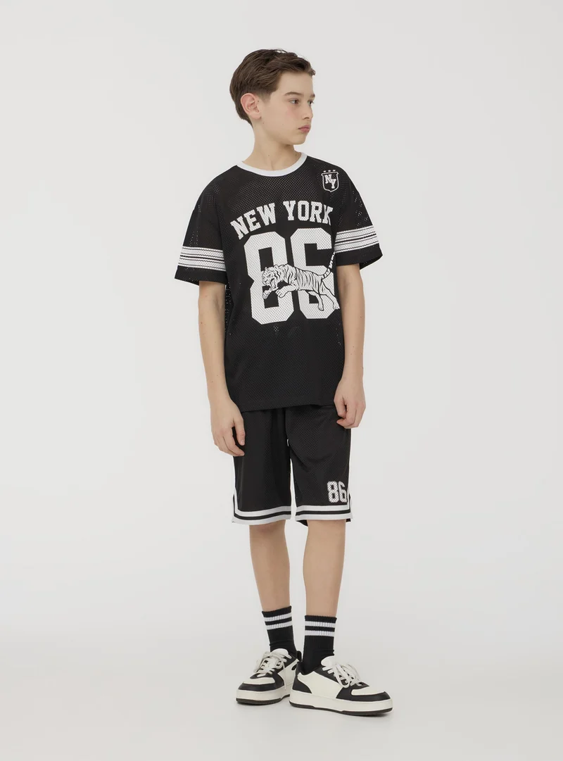 T-shirt a rete con stampa sportiva