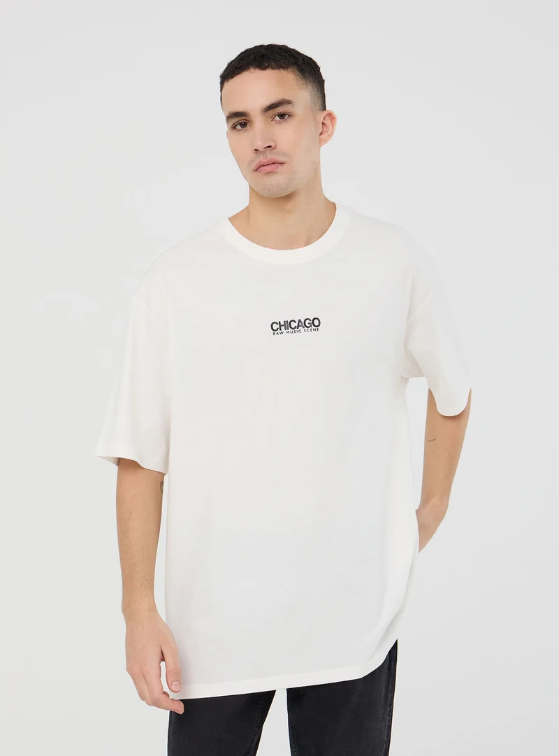 T-shirt over con scritte fronte/retro