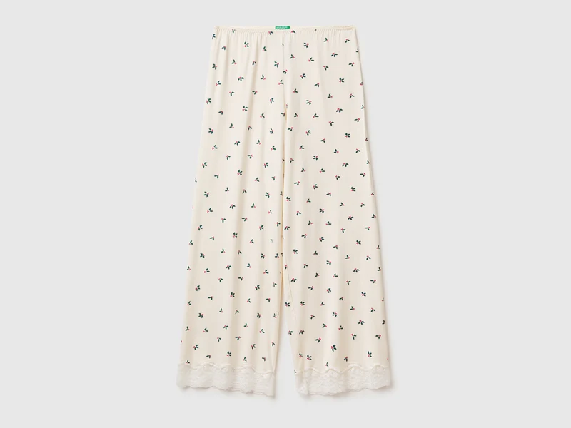 Pantaloni natalizi con stampa agrifogli e pizzo