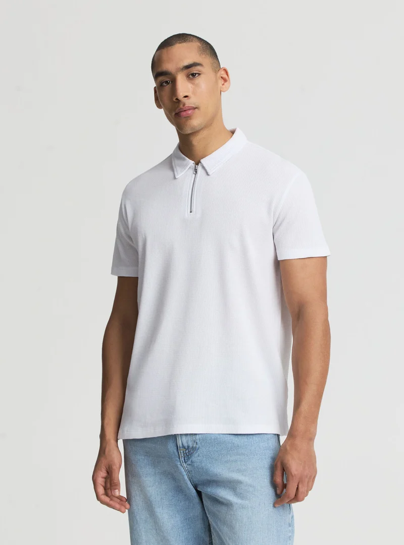 Polo a tinta unita con zip