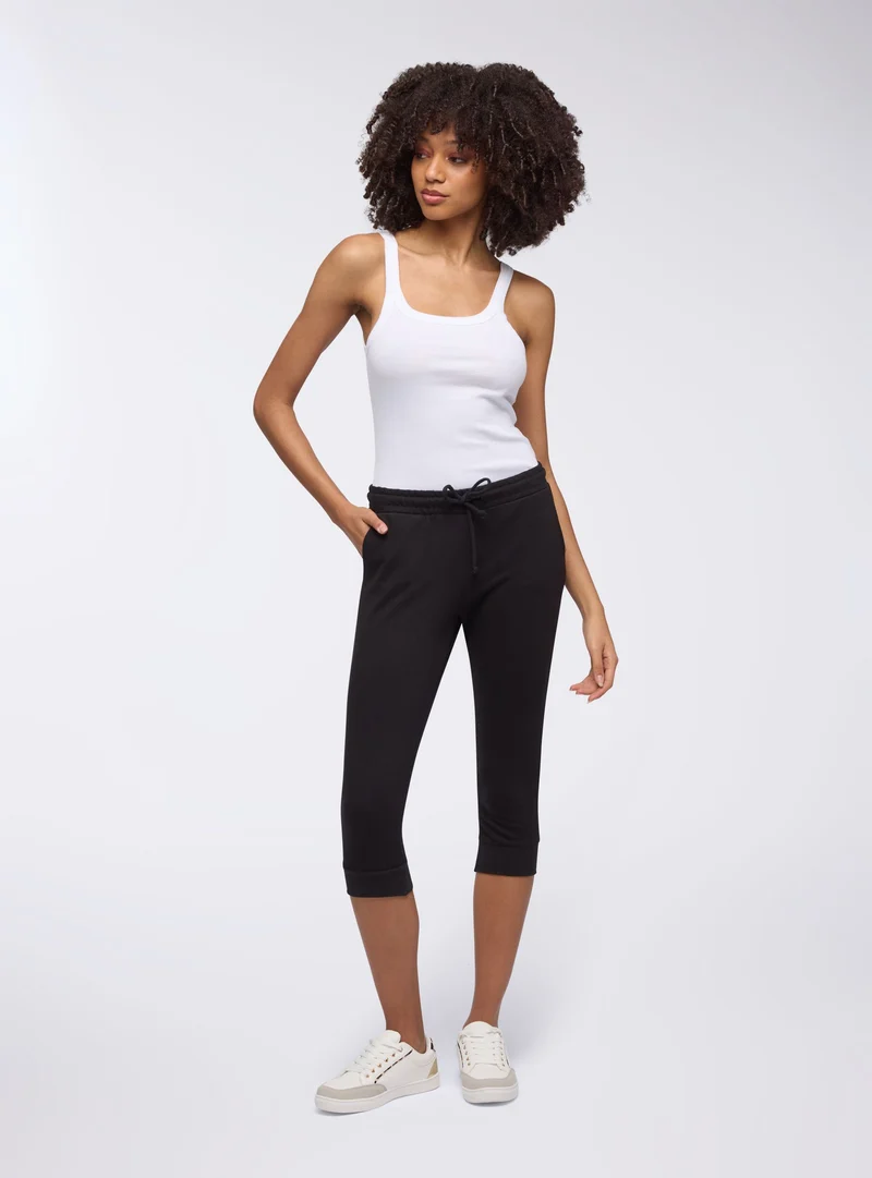 Pantaloni tuta pinocchietto con coulisse