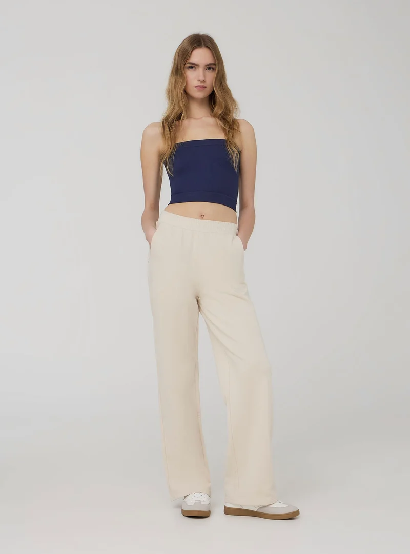 Pantaloni tuta wide leg con ricamo college