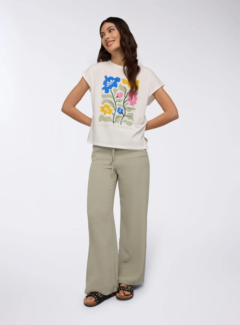 T-shirt ampia con stampa fiori e paillettes