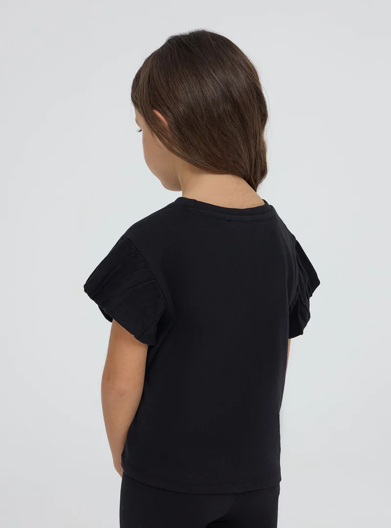 T-shirt con fiocco e scritta