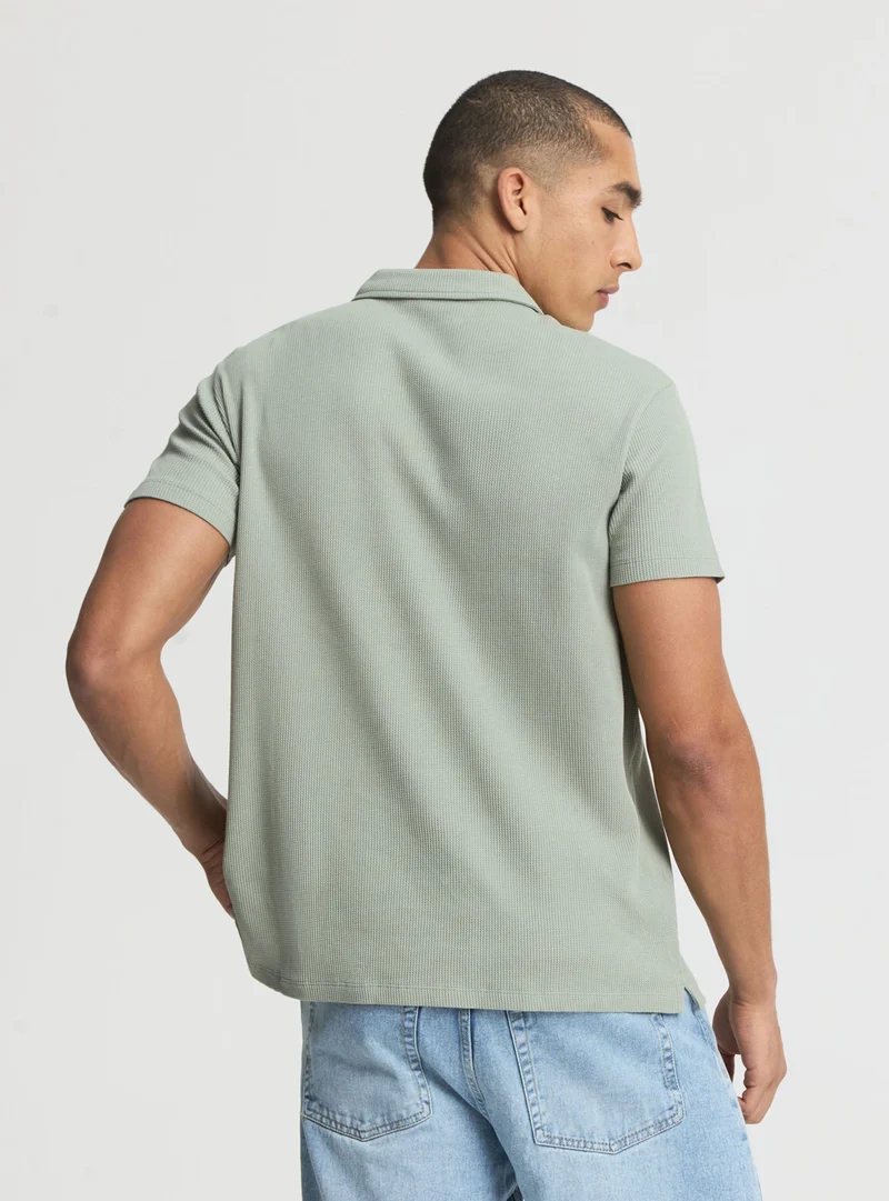 Polo a tinta unita con zip