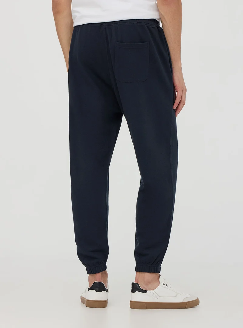 Pantaloni jogger con scritta e coulisse