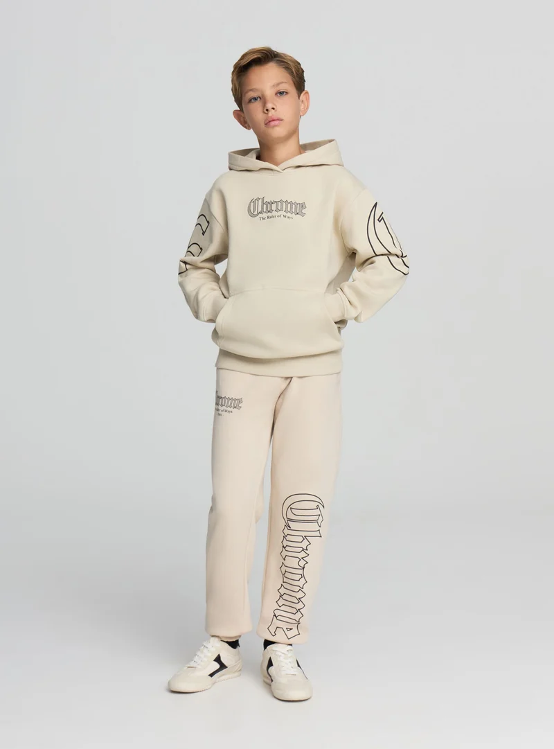 Pantaloni tuta con stampa gotica