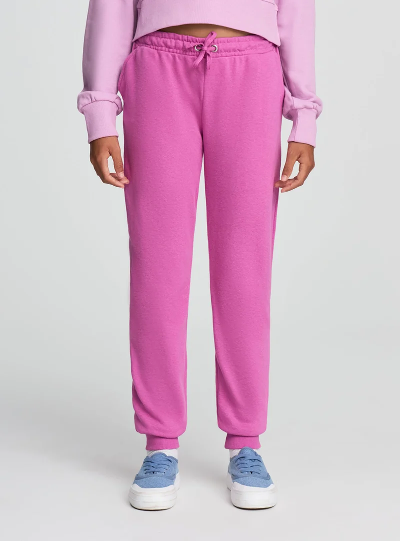 Pantaloni tuta tinta unita