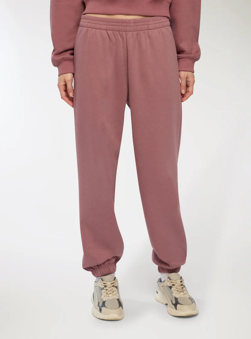 Pantaloni tuta vita alta con polsini
