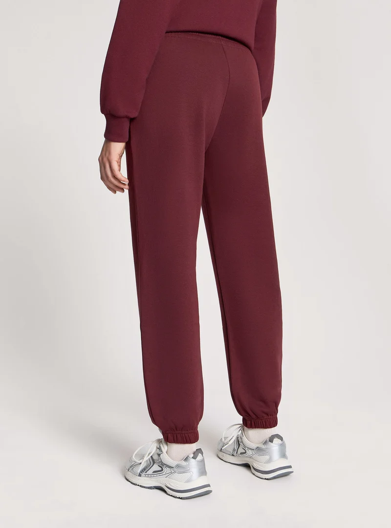 Pantaloni tuta vita alta con polsini