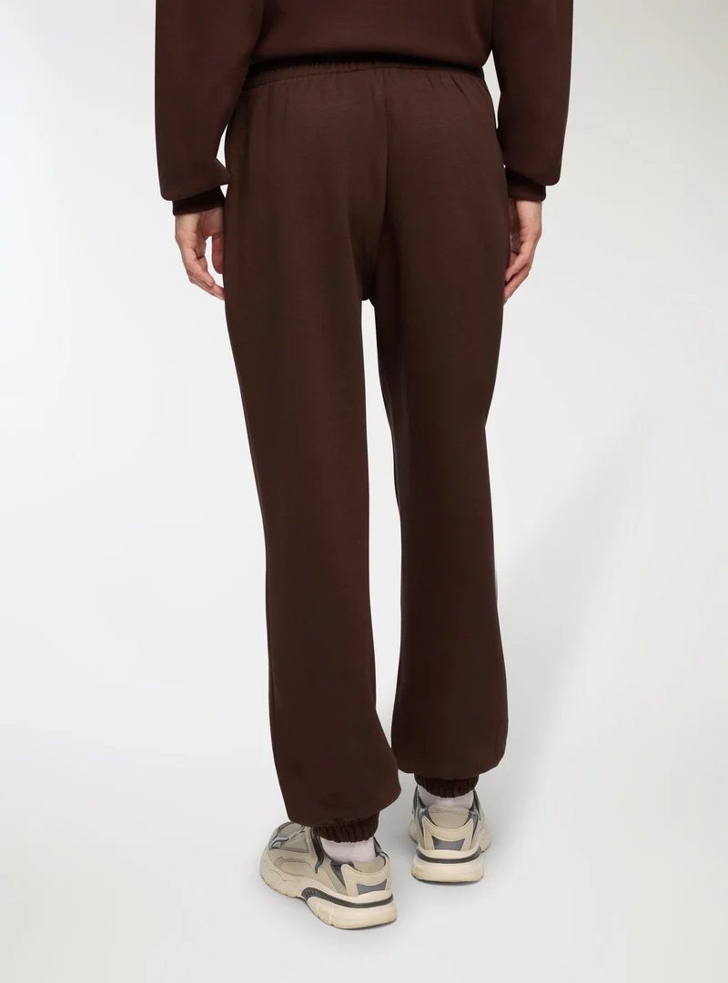 Pantaloni tuta vita alta con polsini