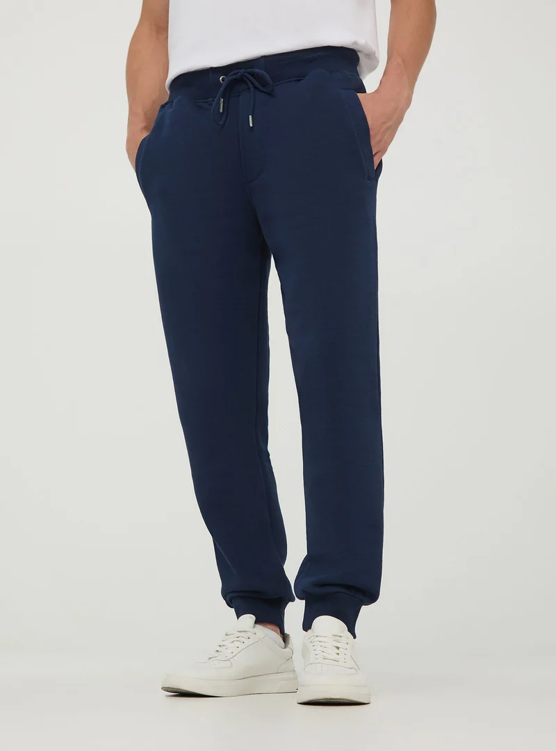 Pantaloni tuta pesanti con coulisse e polsini