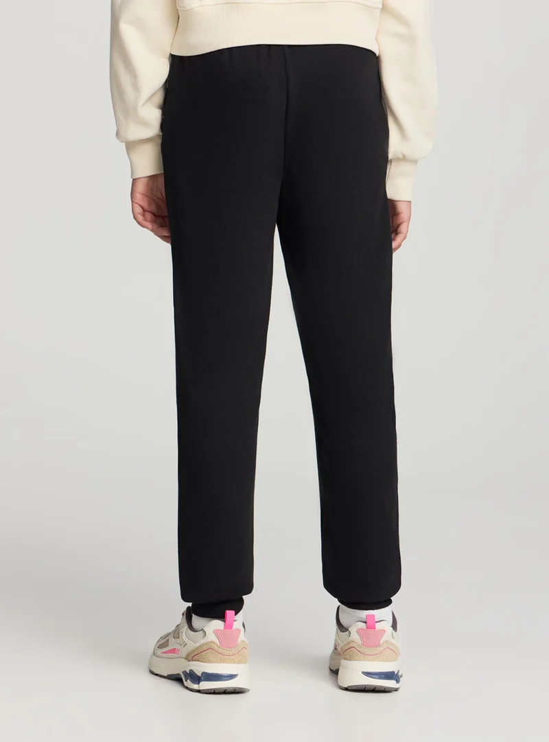 Pantaloni tuta tinta unita